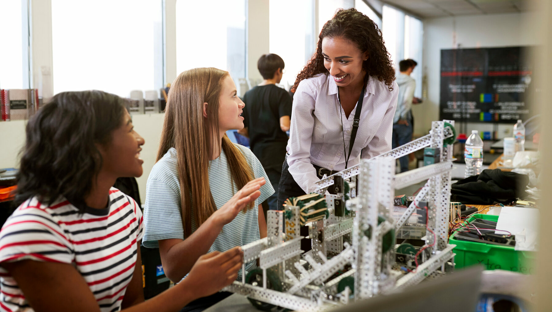 Woman Teacher With Female College Students Building Machine In Science Robotics Or Engineering Class 2023/08/AdobeStock_254379706-e1691637365294.jpeg 